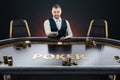 Male croupier at the poker table, poker room. Poker game, casino, Texas hold`em, online game, card games. Modern design, magazine Royalty Free Stock Photo