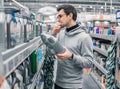 Male customer buying engine lubricating oil in the car supermarket