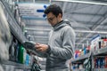 Male customer buying engine lubricating oil in the car supermarket