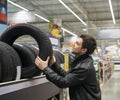 Male customer choosing new tires Royalty Free Stock Photo