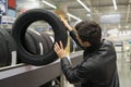 Male customer choosing new tires Royalty Free Stock Photo