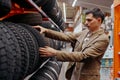 male customer choosing new tires in the supermarket . Royalty Free Stock Photo
