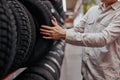 male customer choosing new tires in the supermarket . Royalty Free Stock Photo