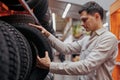 male customer choosing new tires in the supermarket . Royalty Free Stock Photo