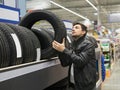 Male customer choosing new tires Royalty Free Stock Photo