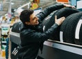 Male customer choosing new tires in the supermarket. Royalty Free Stock Photo