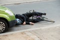 Male cyclist after car accident on road Royalty Free Stock Photo