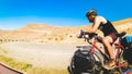 Male cyclist on cycling tour asphalt road stand alone outdoors with mountain panorama. Adventure travel outdoors. Before go uphill