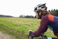 Male cyclist leaning on bike in open countryside, close up Royalty Free Stock Photo