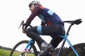 Male cyclist pauses on bike in open countryside, low angle Royalty Free Stock Photo