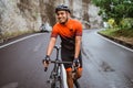 male cyclist pushing his bike and walk after struggling to climb