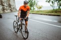 male cyclist pushing his bike and walk after struggling to climb