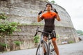 male cyclist pushing his bike and walk after struggling to climb