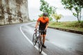 male cyclist pushing his bike and walk after struggling to climb