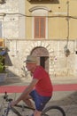 Male cyclist in a red shirt,Trani, Apulia, Italy. summer