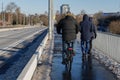 Male cyclist ride bicycle on bicycle lane beside road on the bridge.
