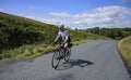 Male cyclist riding a rural road in the Trough of Bowland, UK.