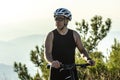 Male cyclist standing with his bike