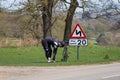 Male cyclist stretching next to a speed sign Royalty Free Stock Photo