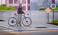 male cyclist taking break during bike ride man with takeaway coffee cup standing near bicycle