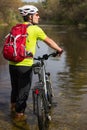 Male cyclist traveling with bike.