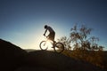Male cyclist on trial bicycle on the top of boulder outdoors Royalty Free Stock Photo