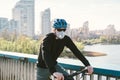 Male cyclist wearing respirator face mask with heavy duty protective filter. Man on bike wearing respirator face mask with heavy