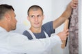 male decorator painting wall with brush indoors Royalty Free Stock Photo