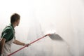 Male decorator painting a wall