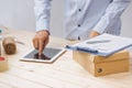 Male deliverer with tablet on work place in post office