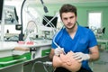 Male dental student practicing on doll.