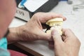 Hands of technician working on 3D printed mold for dental implants Royalty Free Stock Photo