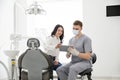 Male dentist with digital tablet. Modern treatment in professional dental clinic
