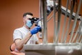 A male dentist looks into a microscope. Modern dentistry using new technologies