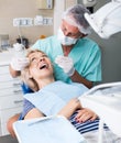 Male dentist treating female patient