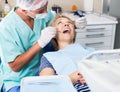 Male dentist treating female patient