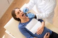 Male Dentist Treating Teeth Of Young Pregnant Woman