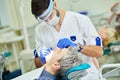 Male dentist at work in clinic