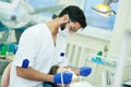 Male dentist at work with young patient
