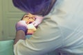 Male dentists examining and working on young female patient.Dentist`s office. Real woman in a chair at the dentist. toned