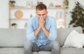 Depressed sad man sitting on couch, thinking about problems Royalty Free Stock Photo