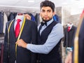 Male designer is creating business image with red tie Royalty Free Stock Photo