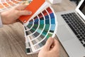 Male designer working with color palette at office table