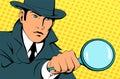 Male detective investigating with a magnifying glass