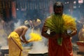 Male devotees perform holy bath ritual with hot turmeric water