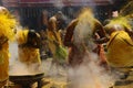 Male devotees perform holy bath ritual with hot turmeric water