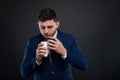 Male director holding take away paper coffee cup