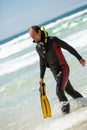 Male diver with diving suit snorkel mask fins on the beach Royalty Free Stock Photo