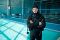 Male diver poses in scuba suit, diving school