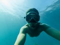 Male diver swims in sea under water with a mask and snorkel Royalty Free Stock Photo